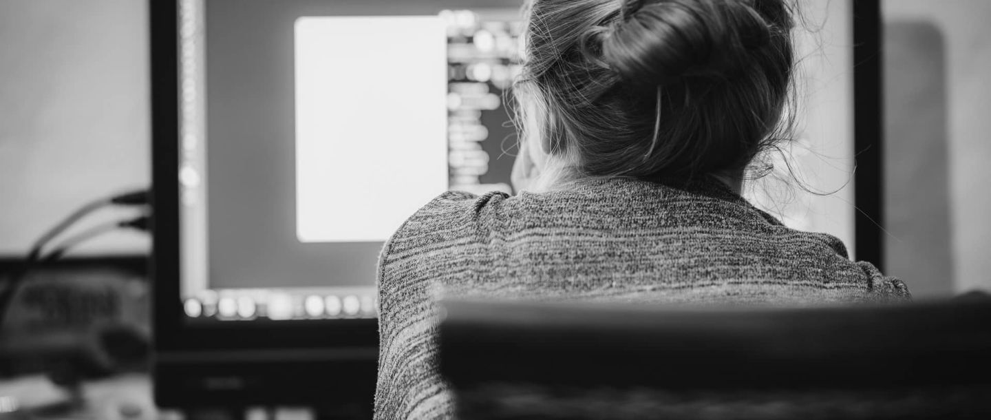 Image representing a freelance coder working on her computer